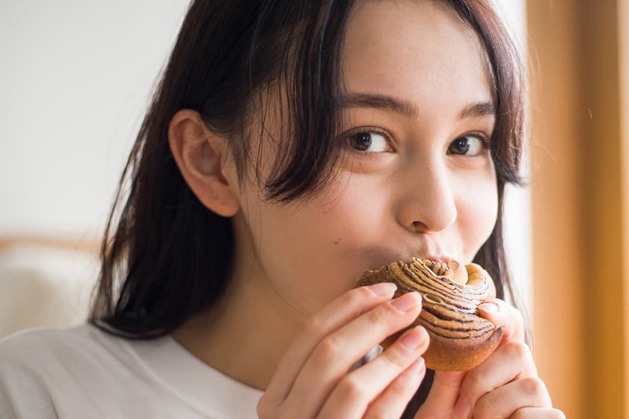 BASE BREAD を食べる女性
